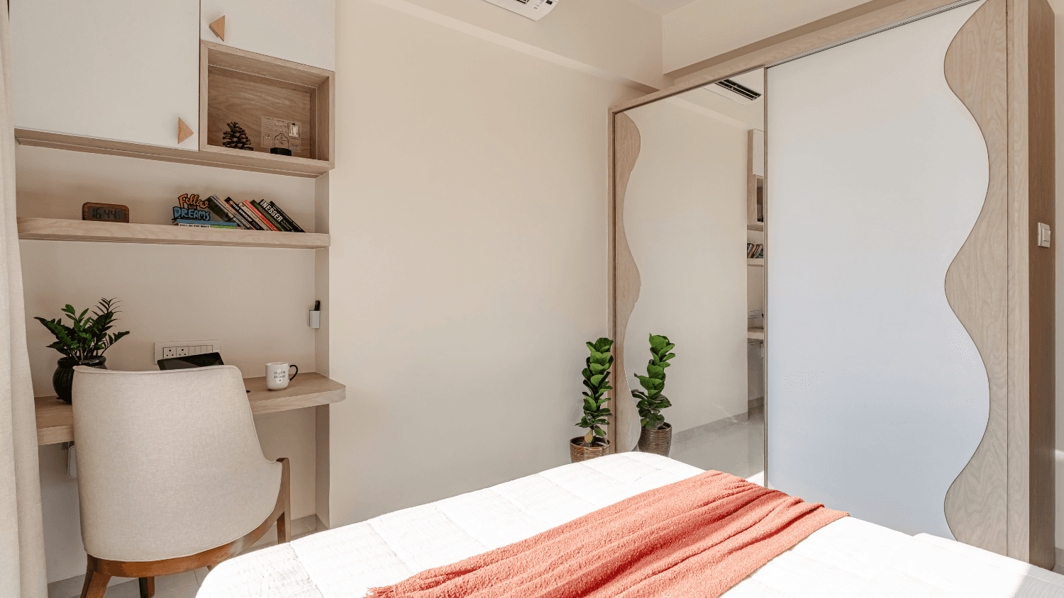 Guest bedroom with a sculpted wardrobe and dedicated study corner