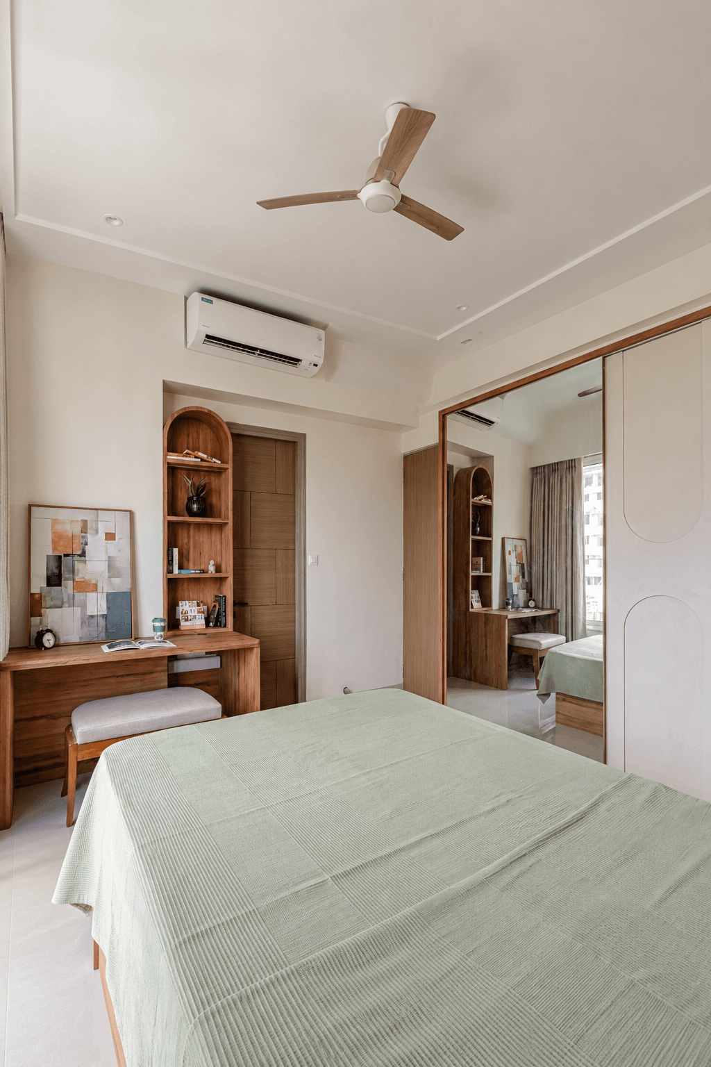 Parents' bedroom with a mirrored wardrobe and built-in study nook